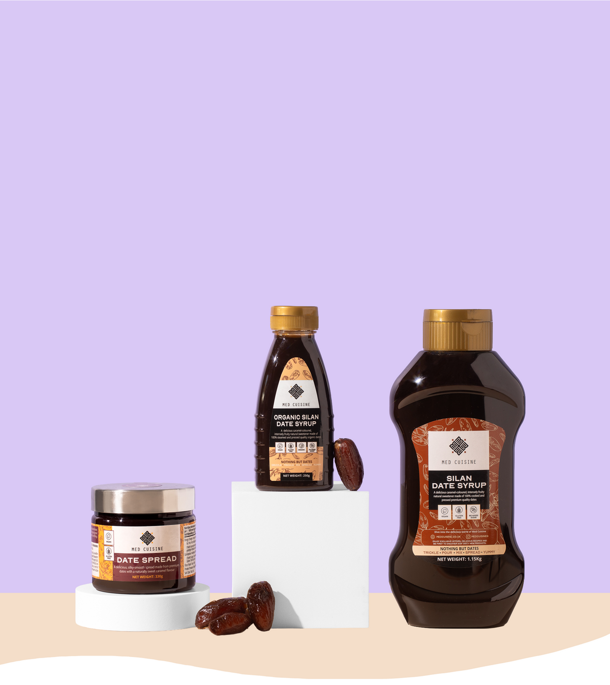 Three bottles of Sweet Alchemy Black Date Syrup and one jar of Date Spread arranged on white pedestals against a lavender background with a beige floor.